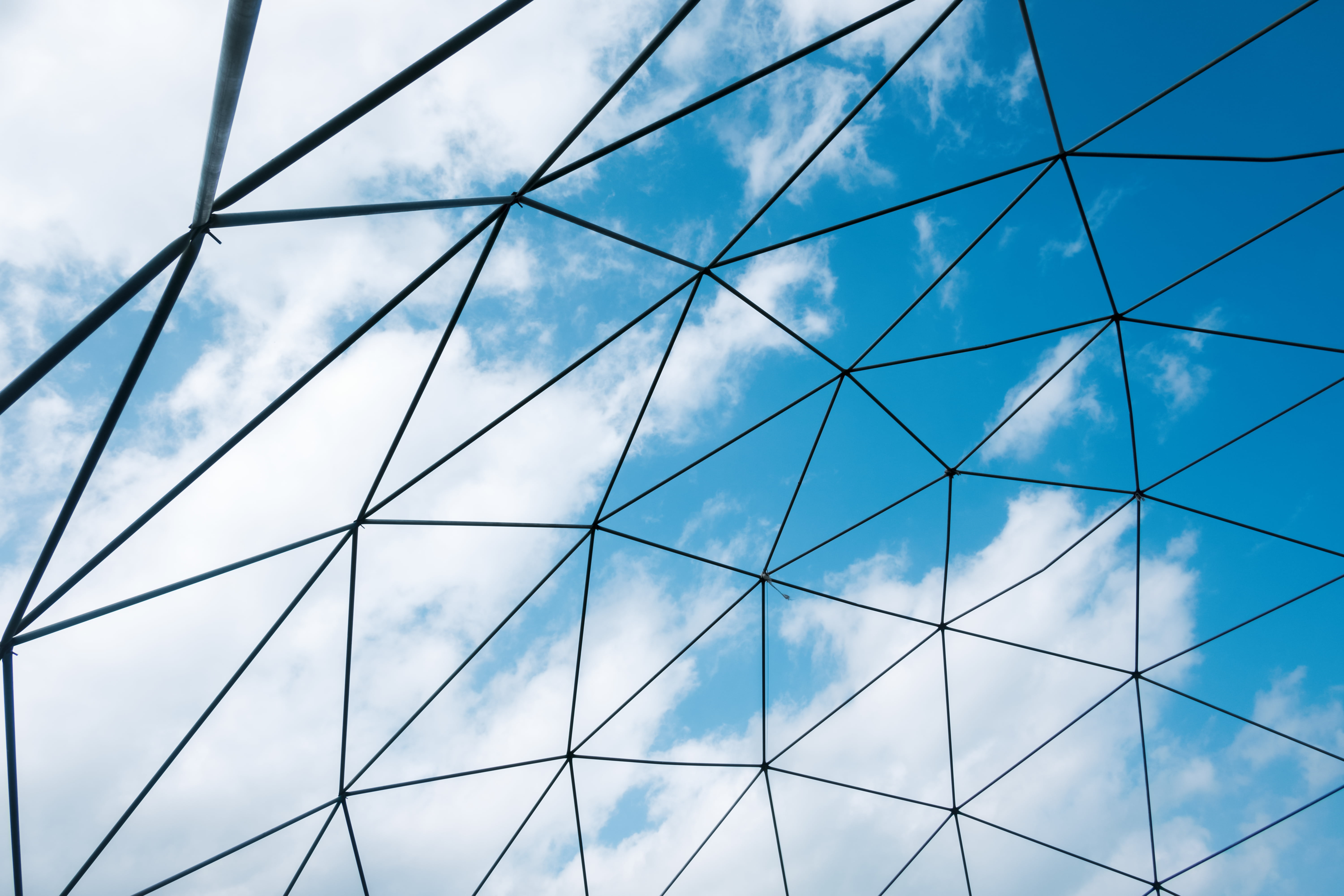 Abstract celling metal construction on blue sky background. Exterior of agriculture greenhouse
